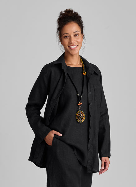 Bias Back Shirt, shown in solid Black, size Small. Worn unbuttoned, layered over the sleeveless Side Pocket Tunic. 100%Linen.