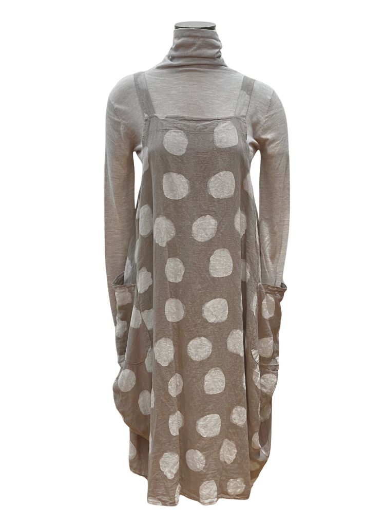 Sleeveless Dot Dress, shown in Taupe Dot) layered over a neutral turtleneck.