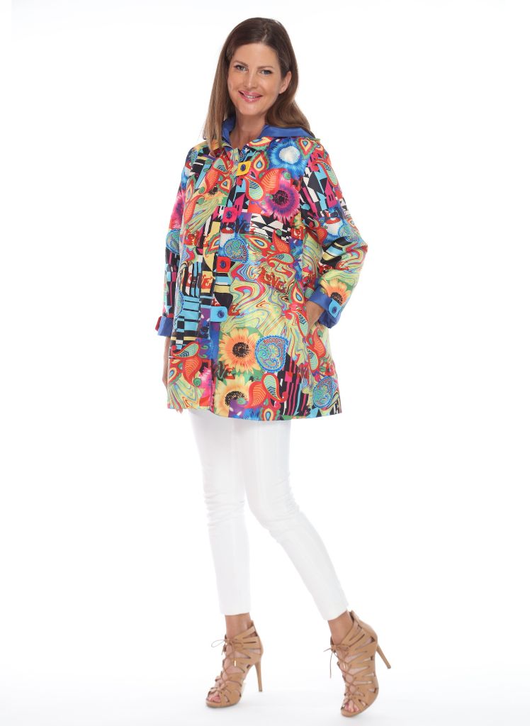 Oopera Rain Coat, shown in Blue, on the reverse (patterned) side. Shown buttoned, with Cuff turned back, and hood on.