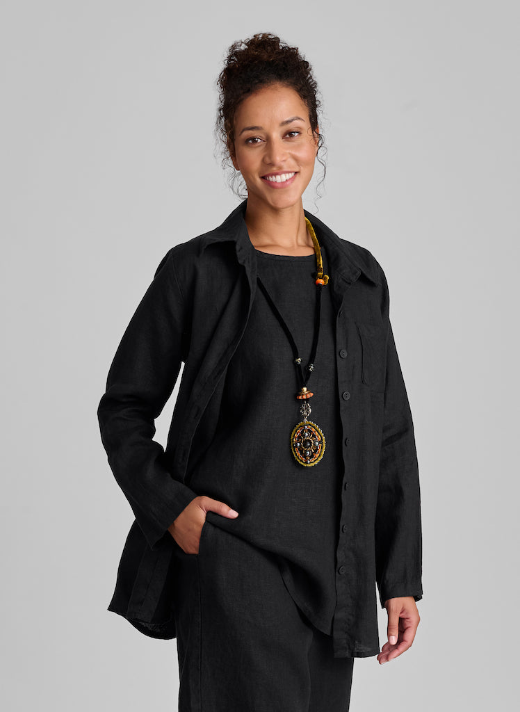 Bias Back Shirt, shown in solid Black, size Small. Worn unbuttoned, layered over the sleeveless Side Pocket Tunic. 100%Linen.