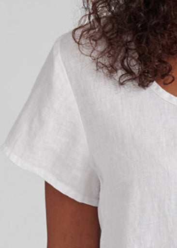 Weightless Tee, shown in White.  Zoomed in on the rounded neckline, and short capped sleeves.