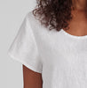 Weightless Tee, shown in White.  Zoomed in on the rounded neckline, and short capped sleeves.