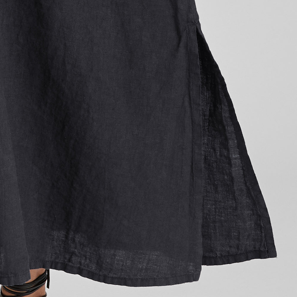 Caftan Dress, shown in Black.  Featuring a close-up of the long hem slit detail, that sits on either side.
