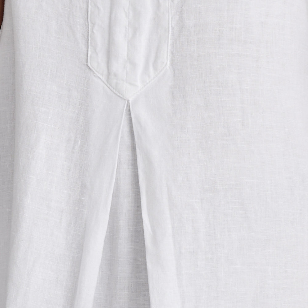 Caftan Dress, shown in White.  Featuring a close-up of the inverted pleat detail on the front, near the waist line.