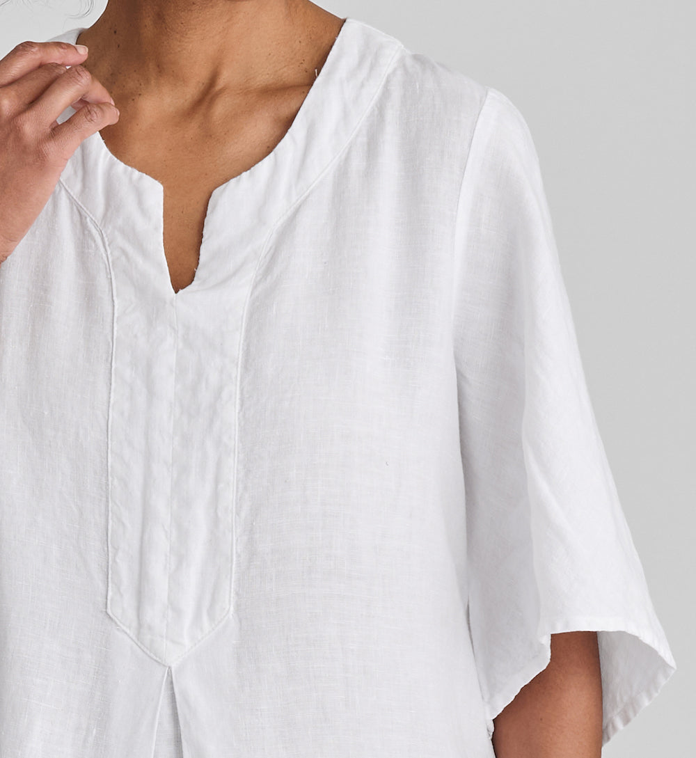Caftan Dress, shown in White.  Featuring close-up of the neckline and flared sleeve detail.