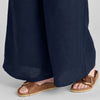 Carefree Pant, shown in Midnight.  Zoomed on wide flowing pant legs, and seam detail along the bottom hem.