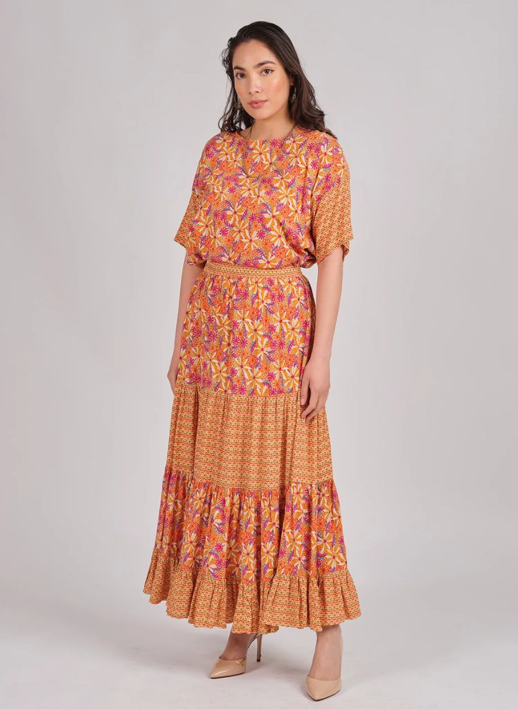 Daisy Print Top (s/m) shown tucked in, paired with the Daisy Print Skirt (o/s), both shown in Peach, for a matching outfit.