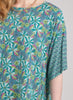 Daisy Top, shown in Turquoise. Features contrasting smaller print on the sleeve.