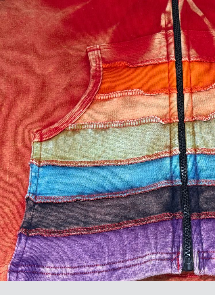 Hooded Jacket, shown in Red Multi.  Featuring the multi-colored rainbow pattern on the front pouch pockets.
