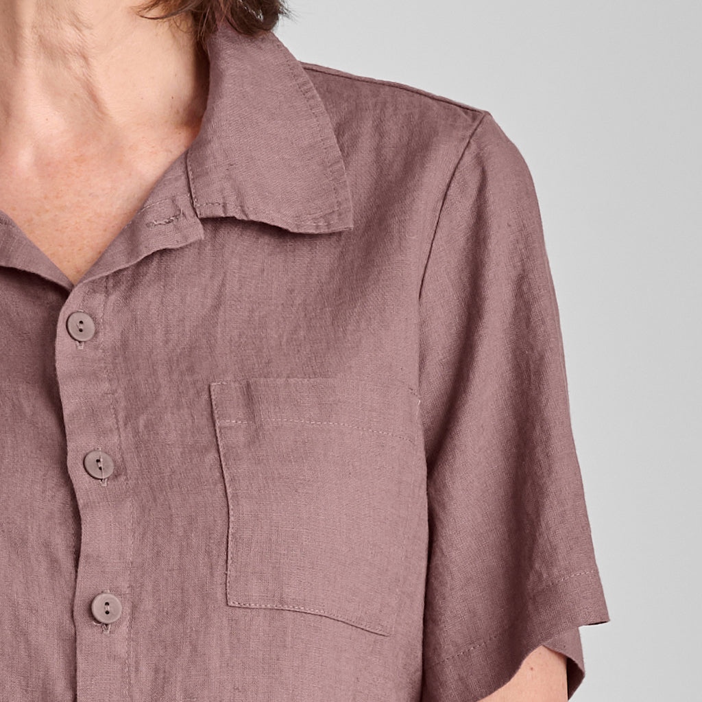 Recamp top, shown in Mauve, size small.   Featuring shirt collar, single chest pocket, short sleeves, and corozo buttons down the front.