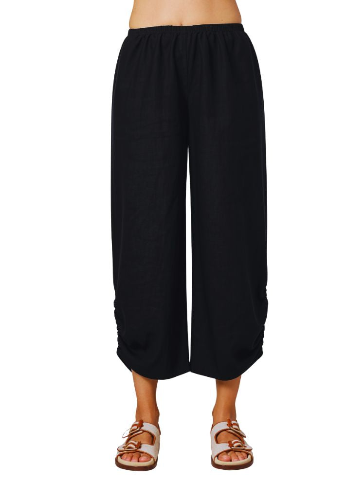 Ruched Pant, shown in Black.  Featuring the full elastic waist, midrise, rounded front hem with cinched sides.  If you are shorter, this pant will land closer to your ankle.  100% Linen, Made in the USA.