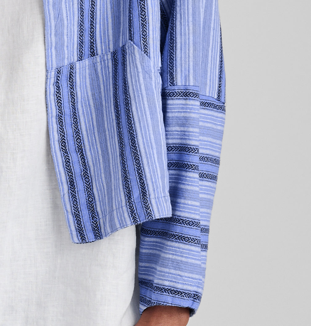Seamly Jacket, shown in Sky Stripe.  Featuring a close up of the pouch-style pocket and pattern/shape of the sleeve.