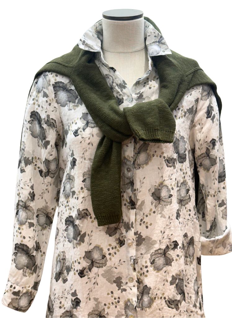 Linen Shirt Dress, shown in White,size Small.  Worn buttoned, paired with a solid Cotton Crewneck Sweater in Olive Green.  one sleeve is shown at full length and the other is shown rolled up to a 3/4 length.  100% Linen, floral print.  Pre-shrunk, Made in the USA by Cut Loose.