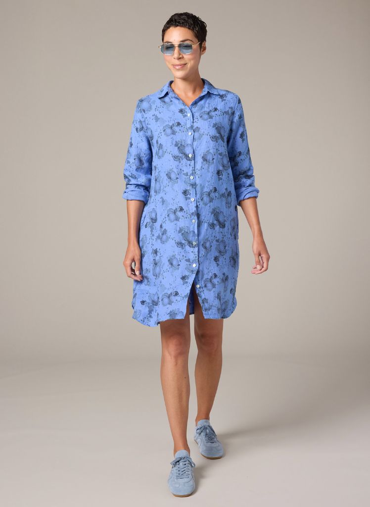 Linen Shirt Dress, shown in Forget me Not (periwinkle blue), size Small on 5’9” model.  Worn buttoned, with long sleeves rolled up.  100% Linen, floral print.  Pre-shrunk, Machine washable, Made in the USA, by Cut Loose.