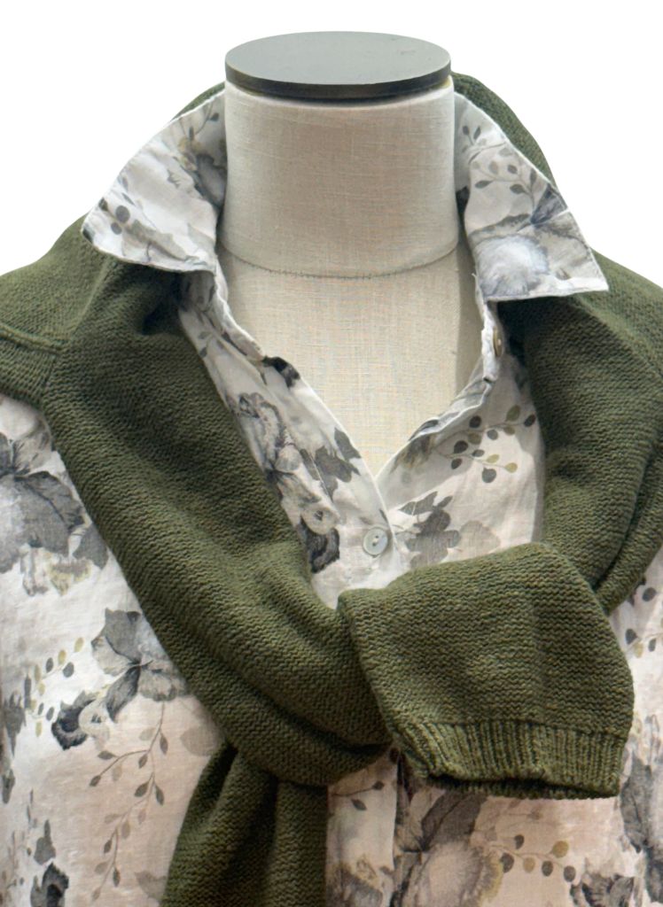 Linen Shirt Dress, shown in White.  Topped with a solid cotton crew Sweater in Olive Green, zoomed in to show subtle shades of green on the leaves within the floral print. 