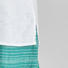Sunny Tank, shown in White, featuring hem slit detail on either side.