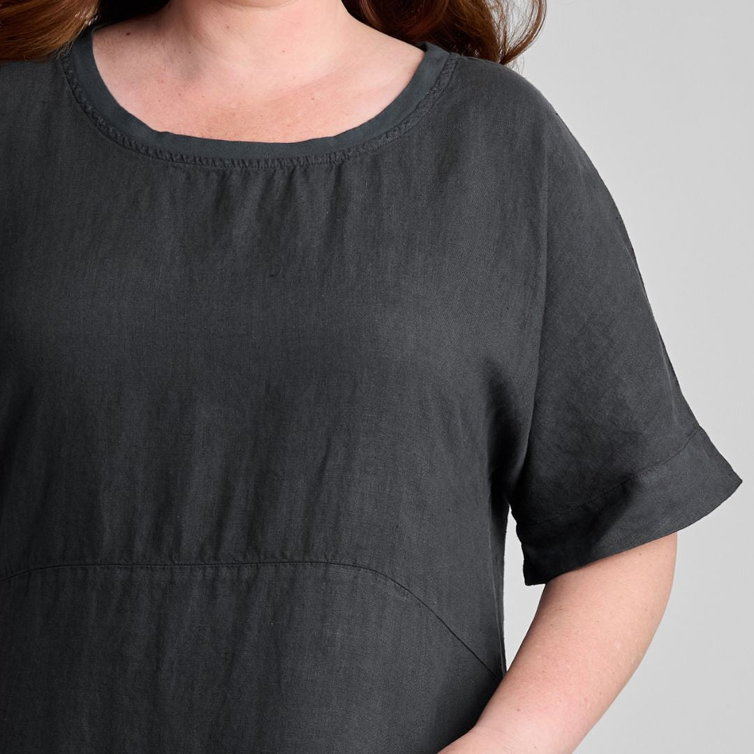 Sunny Side Dress, woven in 100% Linen (body), shown in Faded Black, size Medium.  Zoom on Round Neckline with Cotton Knit trim, empire waist seam detail, elbow-length sleeves finished with a wide hem.