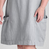 Sunny Side Dress, shown in Fog (light grey), size Medium.  Zoom on the 2 large patch pockets (trimmed in soft Cotton Knit) that sit on either side, along the wide hem, landing at (or just below) the knee.