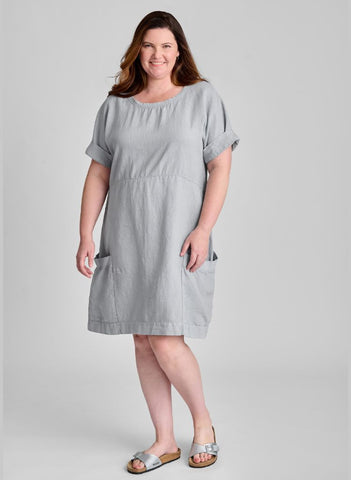 Sunny Side Dress, shown in Fog, size Medium.  A knee length dress, with empire waist detail, and elbow length short sleeves (shown rolled up).  100% Linen (Body) with Cotton Knit Trim along the round neckline and the top edge of the 2 large patch pockets.  Model is 5'9" tall.