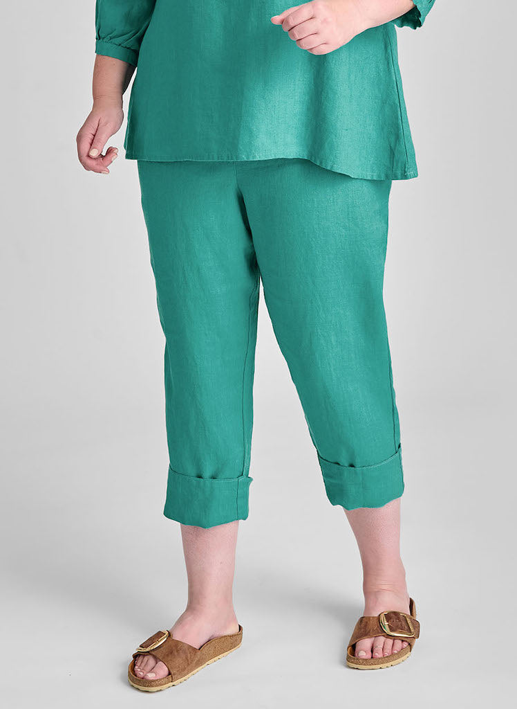 Travel Pant, shown in Lagoon, with pant leg rolled up. Model is 5'9" tall, wearing size Medium. 100% European Linen, Machine Washable.