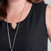 True Dress, shown in Black.  Zoom on Round neckline with v-notch detail, sleeveless with ample shoulder coverage.