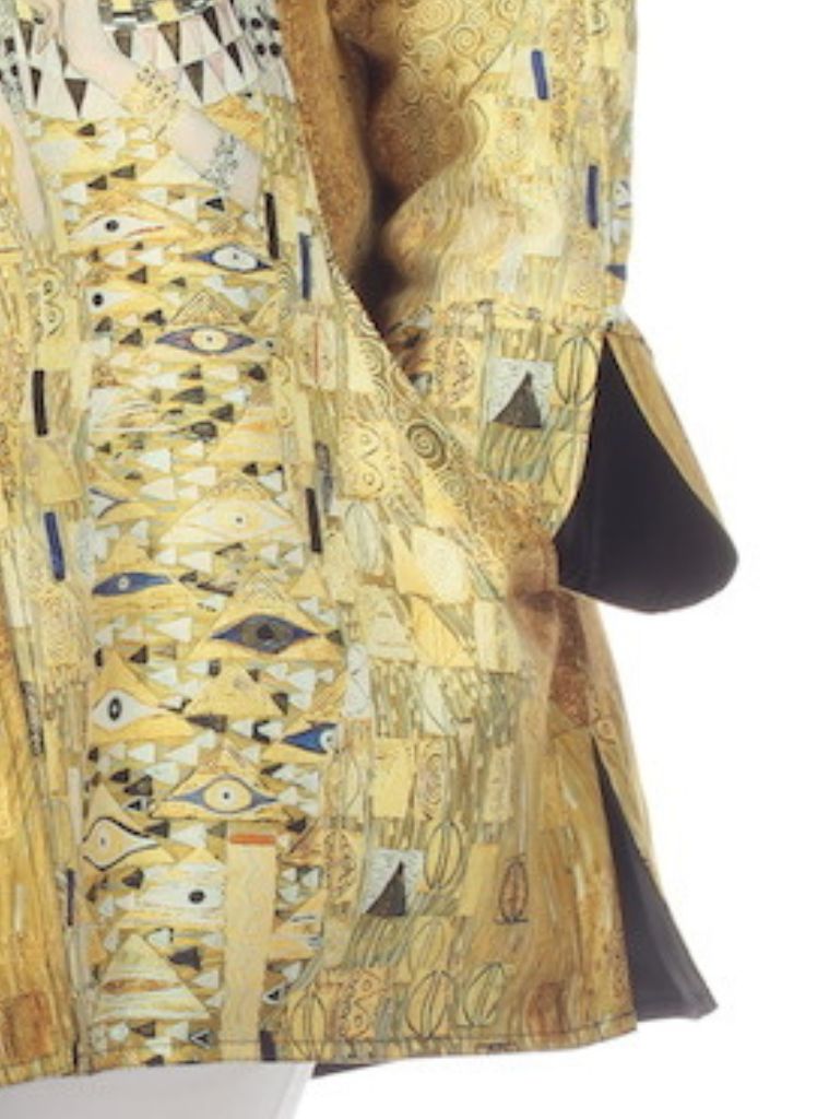 Woman in Gold Rain Coat, zoomed to feature the pocket, side slit, and cuff detail