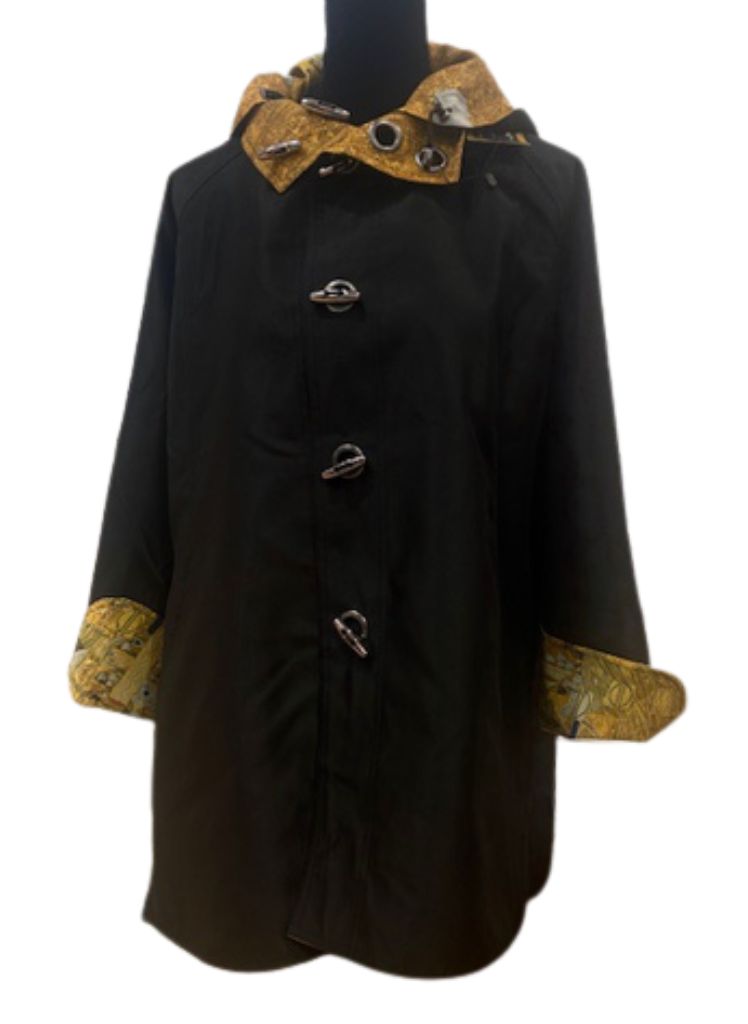 Woman in Gold, shown on the reverse side (solid black) with the pattern peeking through on the collar, hood, and cuff turn back.  Stunning!