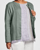 Dis-Cover (shown in Thyme) - a lightweight button-down Linen cardigan, with a high rounded neckline, long sleeves, cut on the bias in back for a contoured fit, woven in 100% Handkerchief-weight Linen (softened), in women's regular and plus sizes, UnderFLAX 2021.