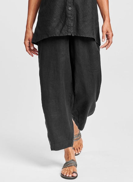 Seamly Pant (shown in solid Black), ankle length linen pant with a full elastic waist, side pockets, and roomy legs that taper along the gathered cuff.