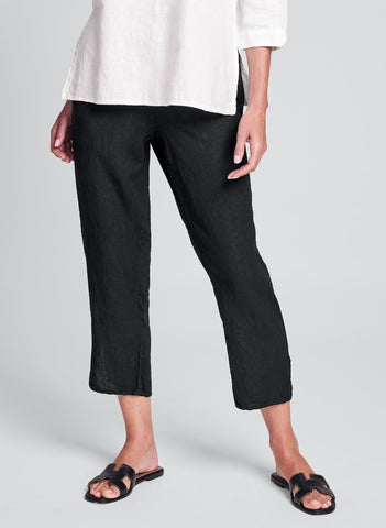 Pocketed Ankle Pant (shown in Black), 100% Linen, flat front and 3/4 elastic waistband, side seam pockets, pant legs that tapering as they go down, ending just above the ankle with hem slits. Available in a variety of solid colors, in women's regular and plus sizes. Collection: FLAX Classics 2021.
