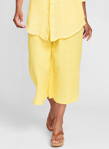 Push Out's (shown in solid Canary) - a cropped linen pant with a full elastic waist, one back pocket, and comfy wide legs, hem finished with side slits. 100% Linen, In Solid colors. FLAX de Soleil 2022.